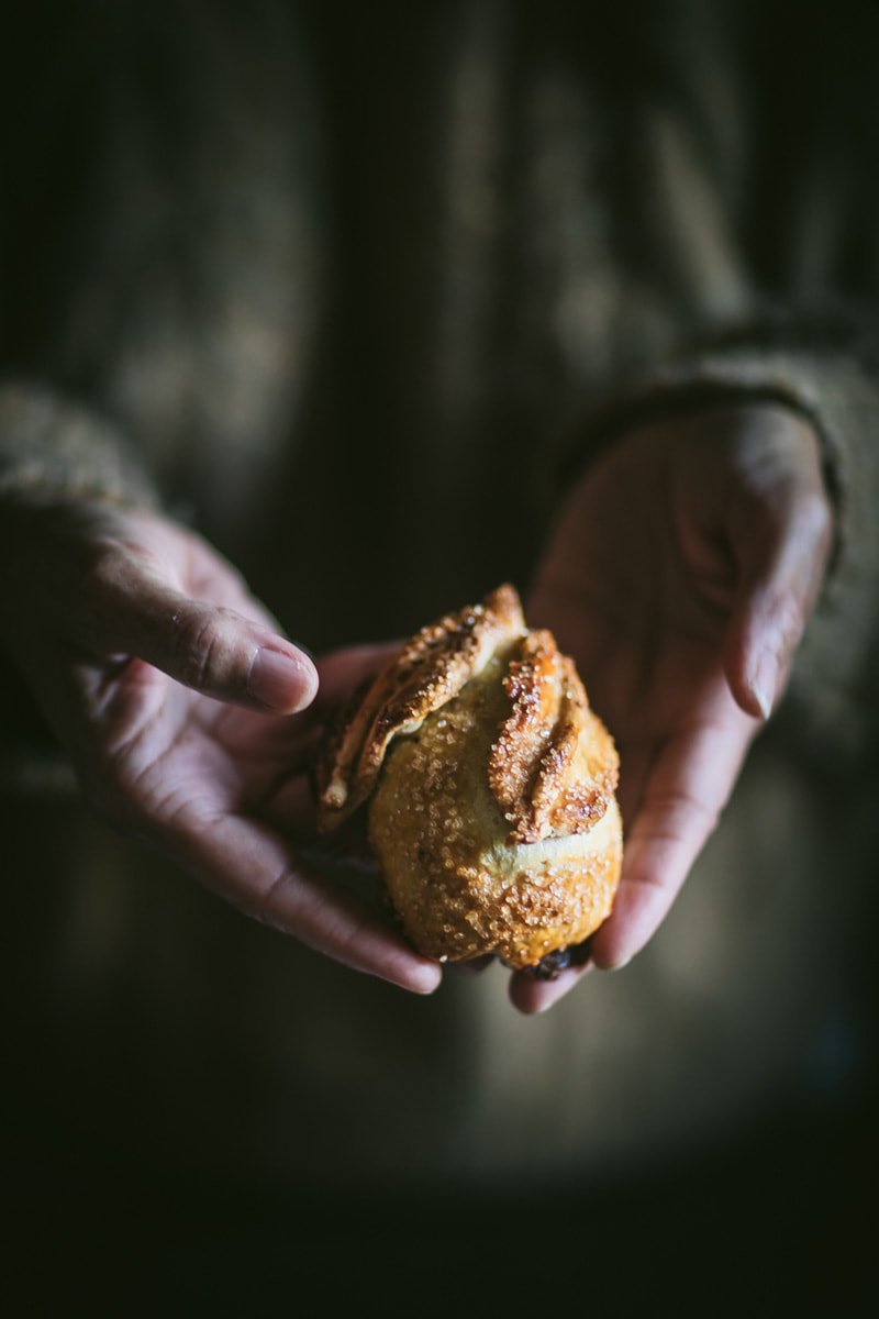 baked pastry covered pear in hands