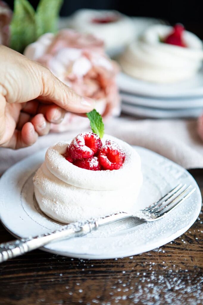 Mint leaf placed on meringue tart
