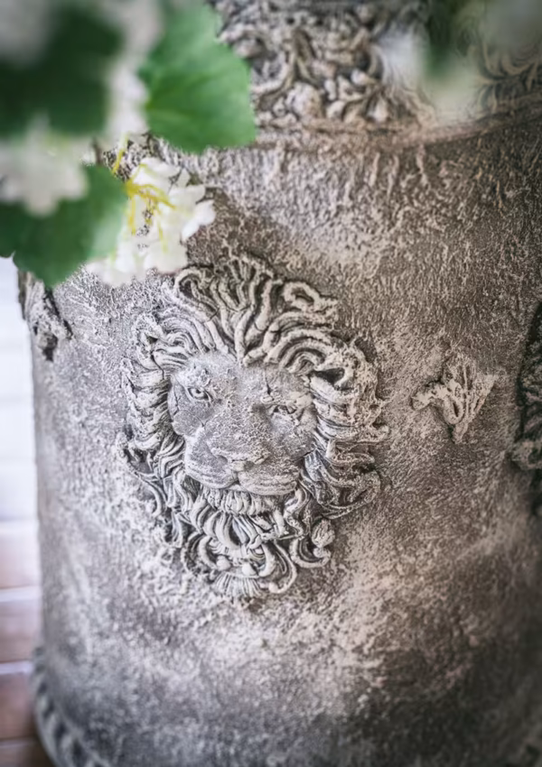 lion face on vase